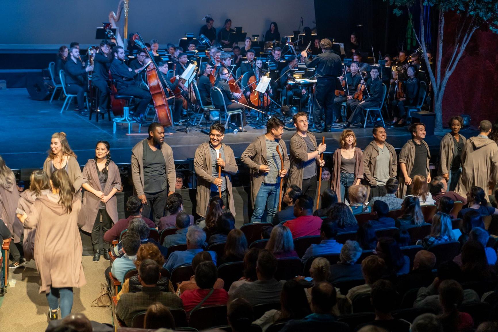 Groups of performing ensembles on stage.